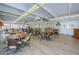 A bright recreation room, complete with tables, chairs, and wood-look flooring at 9945 47Th N Ave # 210, St Petersburg, FL 33708