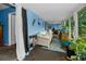 Inviting sunroom featuring blue walls, tiled floors, comfortable seating, and plant accents at 9945 47Th N Ave # 210, St Petersburg, FL 33708