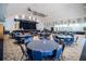 Spacious auditorium with stage, dark blue curtains, and tables and chairs for seating at 10232 Buncombe Way, San Antonio, FL 33576