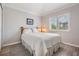 Bright bedroom featuring a comfortable queen-size bed and large window at 10232 Buncombe Way, San Antonio, FL 33576