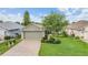Charming single-story home features a well-manicured lawn and two-car garage at 10232 Buncombe Way, San Antonio, FL 33576