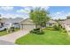 Charming single-story home featuring lush landscaping, a brick driveway, and an attached two-car garage at 10232 Buncombe Way, San Antonio, FL 33576