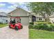 Inviting home with a well-manicured lawn, a golf cart, and a two-car garage at 10232 Buncombe Way, San Antonio, FL 33576