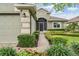 Charming home featuring manicured landscaping, a brick walkway, and a two-car garage at 10232 Buncombe Way, San Antonio, FL 33576