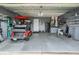 Spacious two-car garage featuring a golf cart and ample storage shelves at 10232 Buncombe Way, San Antonio, FL 33576