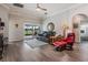 Well-lit living room featuring hardwood floors, neutral paint, and easy access to the outdoor lanai at 10232 Buncombe Way, San Antonio, FL 33576