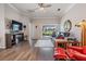 Cozy living room featuring hardwood floors, a ceiling fan, and a sliding glass door to the outside at 10232 Buncombe Way, San Antonio, FL 33576