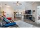 Spacious open-concept living room with wood floors, ceiling fan and fireplace at 10232 Buncombe Way, San Antonio, FL 33576