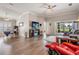 Spacious living room with hardwood floors, neutral walls, and sliding glass doors to screened porch at 10232 Buncombe Way, San Antonio, FL 33576