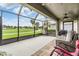 Relaxing screened porch with comfortable seating and panoramic views of the golf course at 10232 Buncombe Way, San Antonio, FL 33576