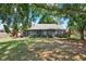 The large backyard features a screened-in porch bordered by well maintained flowerbeds at 10314 Deepbrook Dr, Riverview, FL 33569