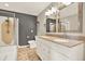 Bathroom featuring double sinks, granite countertops, and walk-in shower with a glass door at 10314 Deepbrook Dr, Riverview, FL 33569