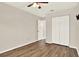 Bedroom featuring wood floors, a ceiling fan, and a double-door closet at 10314 Deepbrook Dr, Riverview, FL 33569