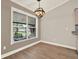 Dining Room featuring a stylish light fixture, hardwood floors, and a large window view at 10314 Deepbrook Dr, Riverview, FL 33569
