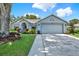 Exterior shot of single story home with two car garage and walkway at 10314 Deepbrook Dr, Riverview, FL 33569