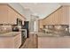 Modern kitchen with wooden cabinetry, backsplash and stainless steel appliances at 10314 Deepbrook Dr, Riverview, FL 33569