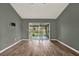 Open living room with hardwood floors and sliding door access to the screened patio at 10314 Deepbrook Dr, Riverview, FL 33569