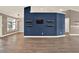 Living room with hardwood floors, with blue accent wall and view to other living spaces at 10314 Deepbrook Dr, Riverview, FL 33569