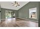 Spacious living room with hardwood floors, ceiling fan, and sliding door access to the backyard at 10314 Deepbrook Dr, Riverview, FL 33569