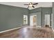 Main bedroom featuring hardwood floors, ensuite bathroom, ceiling fan and high ceilings at 10314 Deepbrook Dr, Riverview, FL 33569