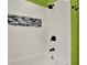 Modern shower with white subway tile, black fixtures, and decorative accent tiling at 10314 Deepbrook Dr, Riverview, FL 33569