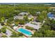 Aerial view of community pool and neighboring homes surrounded by lush trees and landscaping at 10422 Fenceline Rd, New Port Richey, FL 34655