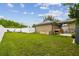 Expansive backyard with a patio, outdoor kitchen, and a basketball hoop at 10422 Fenceline Rd, New Port Richey, FL 34655