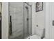 Bathroom features a glass shower with pebble floor, and toilet at 10422 Fenceline Rd, New Port Richey, FL 34655