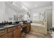 Bathroom with granite countertop, soaking tub and glass enclosed shower at 10422 Fenceline Rd, New Port Richey, FL 34655