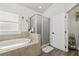 Bathroom with soaking tub and separate glass shower at 10422 Fenceline Rd, New Port Richey, FL 34655
