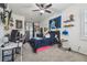 Bedroom features a ceiling fan, carpeted floors, and shelves for décor at 10422 Fenceline Rd, New Port Richey, FL 34655