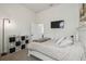 Bright bedroom featuring a TV, storage cube shelving, and neutral décor at 10422 Fenceline Rd, New Port Richey, FL 34655