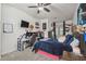 Bedroom features a ceiling fan, carpeted floors, and desk area at 10422 Fenceline Rd, New Port Richey, FL 34655