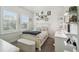 Charming bedroom with ample natural light, decorative wall art, and a vanity area at 10422 Fenceline Rd, New Port Richey, FL 34655