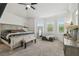 Spacious bedroom featuring large windows, ceiling fan, and neutral color palette at 10422 Fenceline Rd, New Port Richey, FL 34655