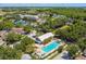 Aerial view of the community pool surrounded by trees and neighborhood homes at 10422 Fenceline Rd, New Port Richey, FL 34655