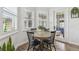 Cozy dining area featuring natural light, a round table with chairs, and plantation shutters at 10422 Fenceline Rd, New Port Richey, FL 34655