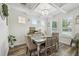 Elegant dining room featuring coffered ceiling, hardwood floors, and abundant natural light at 10422 Fenceline Rd, New Port Richey, FL 34655
