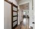 Foyer featuring barn door with frosted panes and wood look floors at 10422 Fenceline Rd, New Port Richey, FL 34655
