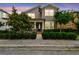 Charming two-story home featuring a covered porch, landscaped yard, and well-manicured shrubbery at 10422 Fenceline Rd, New Port Richey, FL 34655
