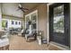 Charming covered front porch with comfortable seating and brick flooring, perfect for relaxing outdoors at 10422 Fenceline Rd, New Port Richey, FL 34655