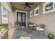 Inviting covered front porch with stylish furniture and decor, creating a cozy outdoor living space at 10422 Fenceline Rd, New Port Richey, FL 34655