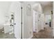 Hallway featuring multiple doorways and modern decor at 10422 Fenceline Rd, New Port Richey, FL 34655