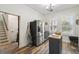 Kitchen view of stainless steel refrigerator, butcher block island, and view to staircase at 10422 Fenceline Rd, New Port Richey, FL 34655