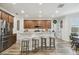 Bright kitchen features wood cabinets, stainless steel appliances, breakfast bar with seating, and recessed lighting at 10422 Fenceline Rd, New Port Richey, FL 34655