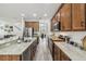 Spacious kitchen with stainless steel appliances, granite countertops, and a view into the adjacent living area at 10422 Fenceline Rd, New Port Richey, FL 34655