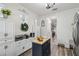 Bright kitchen features an island with butcher block top, built-in cabinets, and wood-look flooring at 10422 Fenceline Rd, New Port Richey, FL 34655