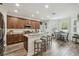 Open kitchen featuring a breakfast bar, wooden cabinetry and hardwood floors at 10422 Fenceline Rd, New Port Richey, FL 34655
