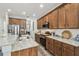 Well-lit kitchen featuring modern appliances, wood cabinets, granite countertops, and stylish fixtures throughout at 10422 Fenceline Rd, New Port Richey, FL 34655
