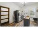Kitchen view of stainless steel refrigerator, butcher block island, and decorative wood door at 10422 Fenceline Rd, New Port Richey, FL 34655